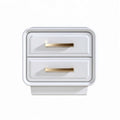 White nightstand with two drawers and gold handles suitable for modern bedrooms